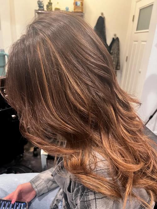 Lived-In Hair Color in the Denver Metro Area This soft brunette balayage features warm caramel tones(..)